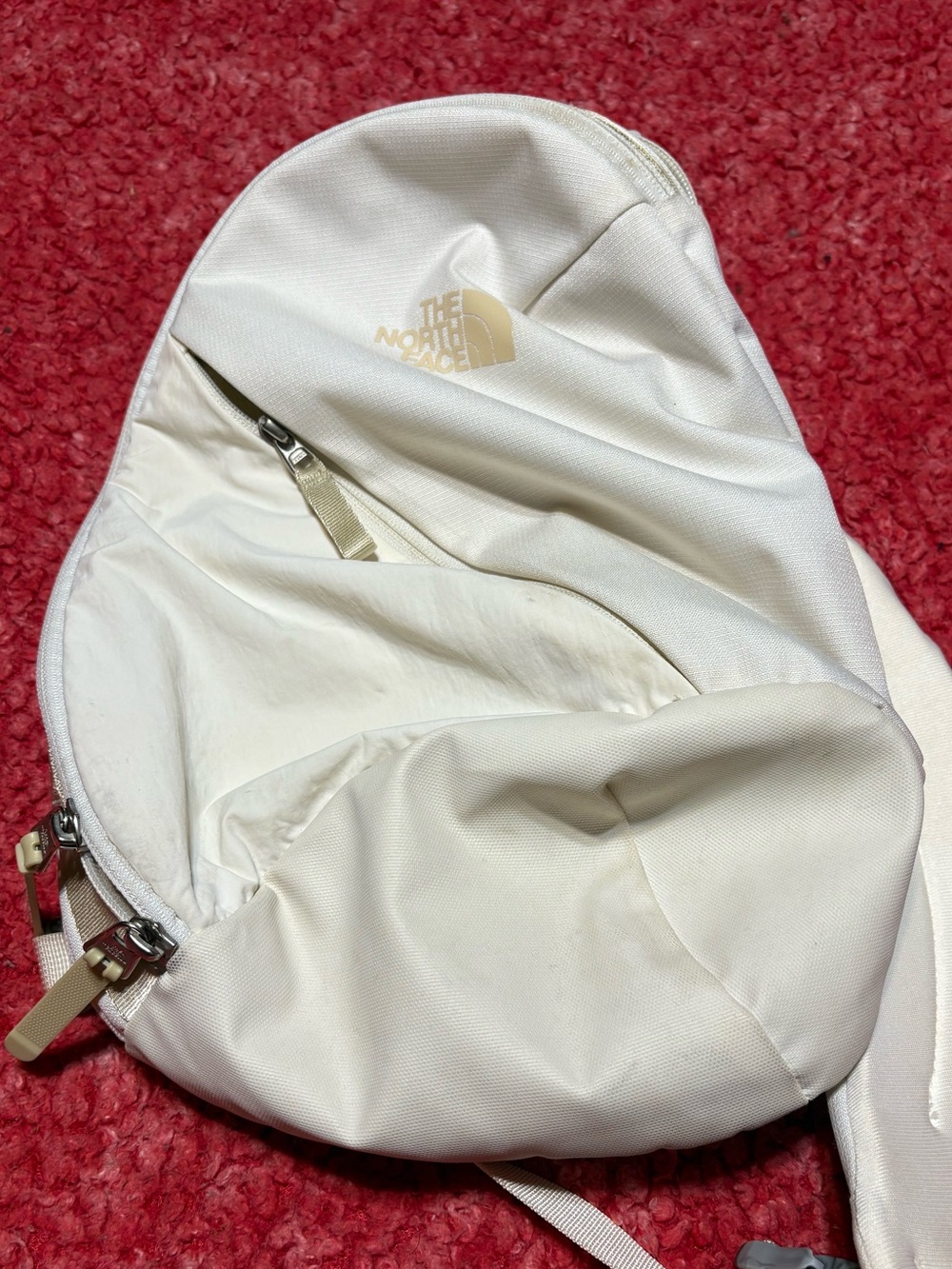 The North Face Cream Sling Backpack with Subtle Logo